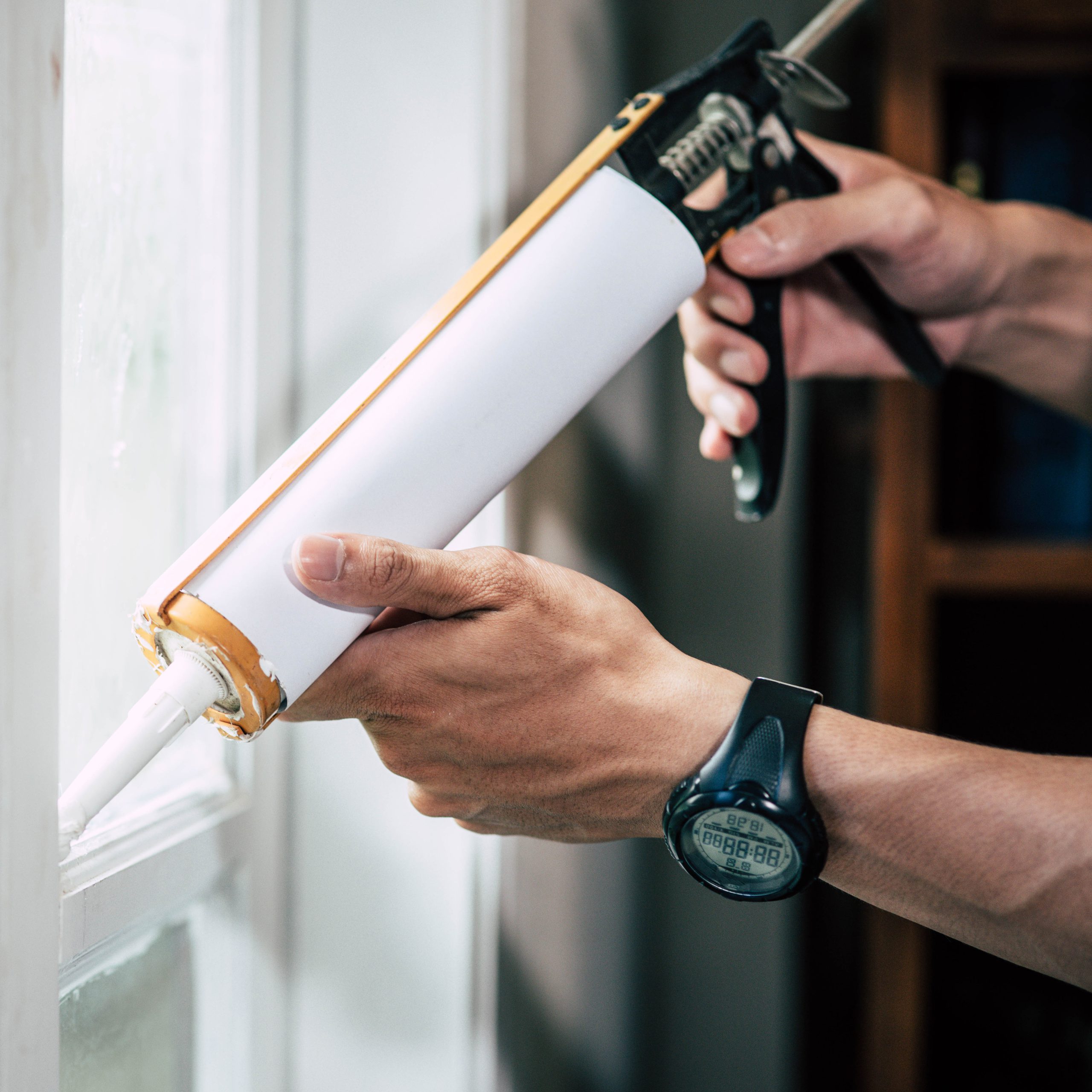 Carpenter holds glue attaches window scaled